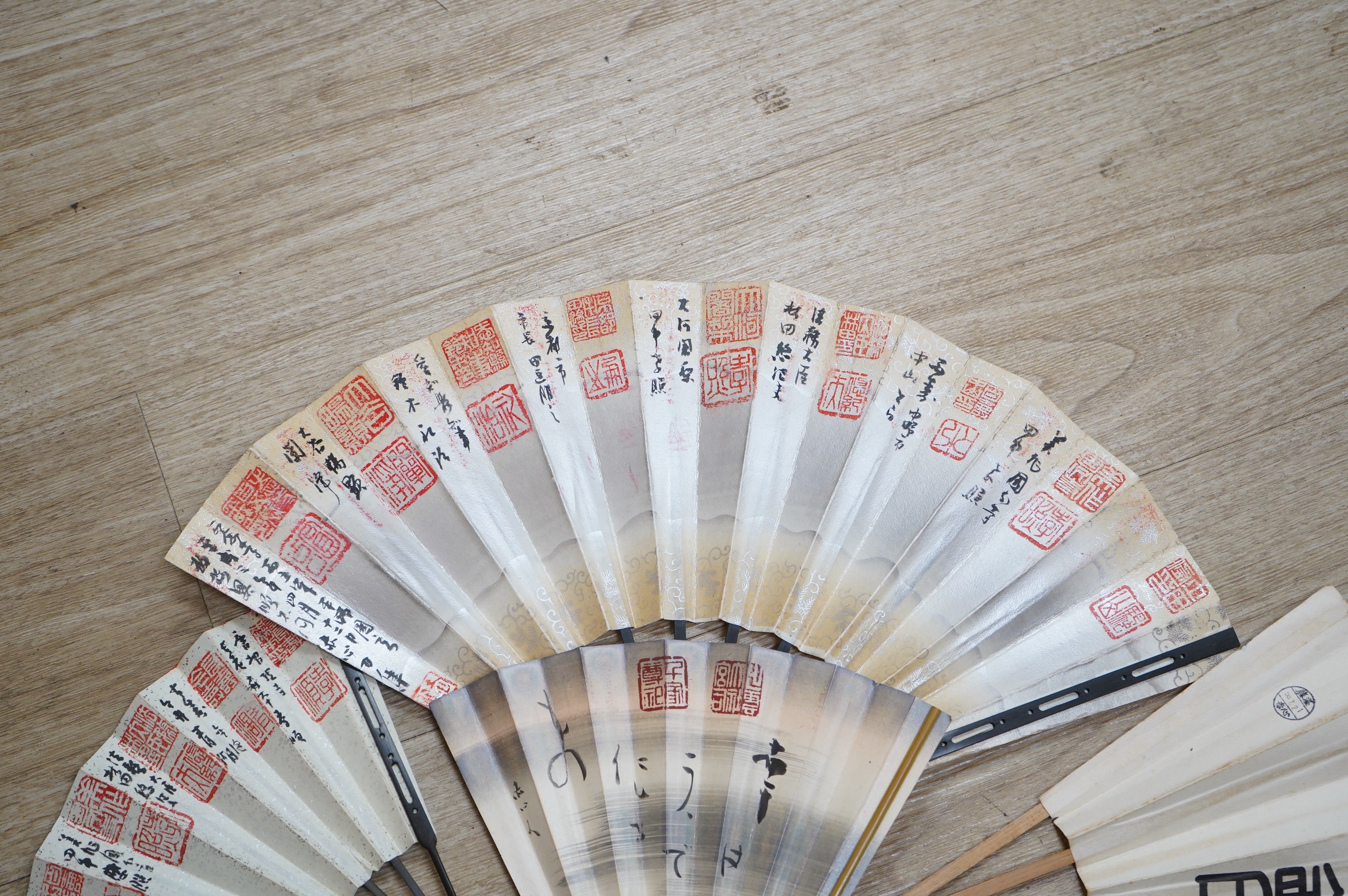 A collection of Japanese 20th century paper leaf fans, one hand painted with koi. Condition - varies, some rips/tears